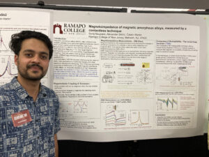 Student posing in front of their research poster on the magnetoimpedance of magnetic amorphous alloys, SCHOLARS' DAY, April 16th, 2024.