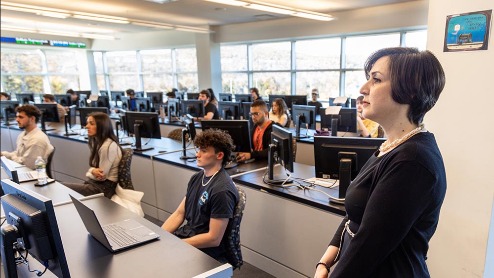 Professor in a classroom with computers